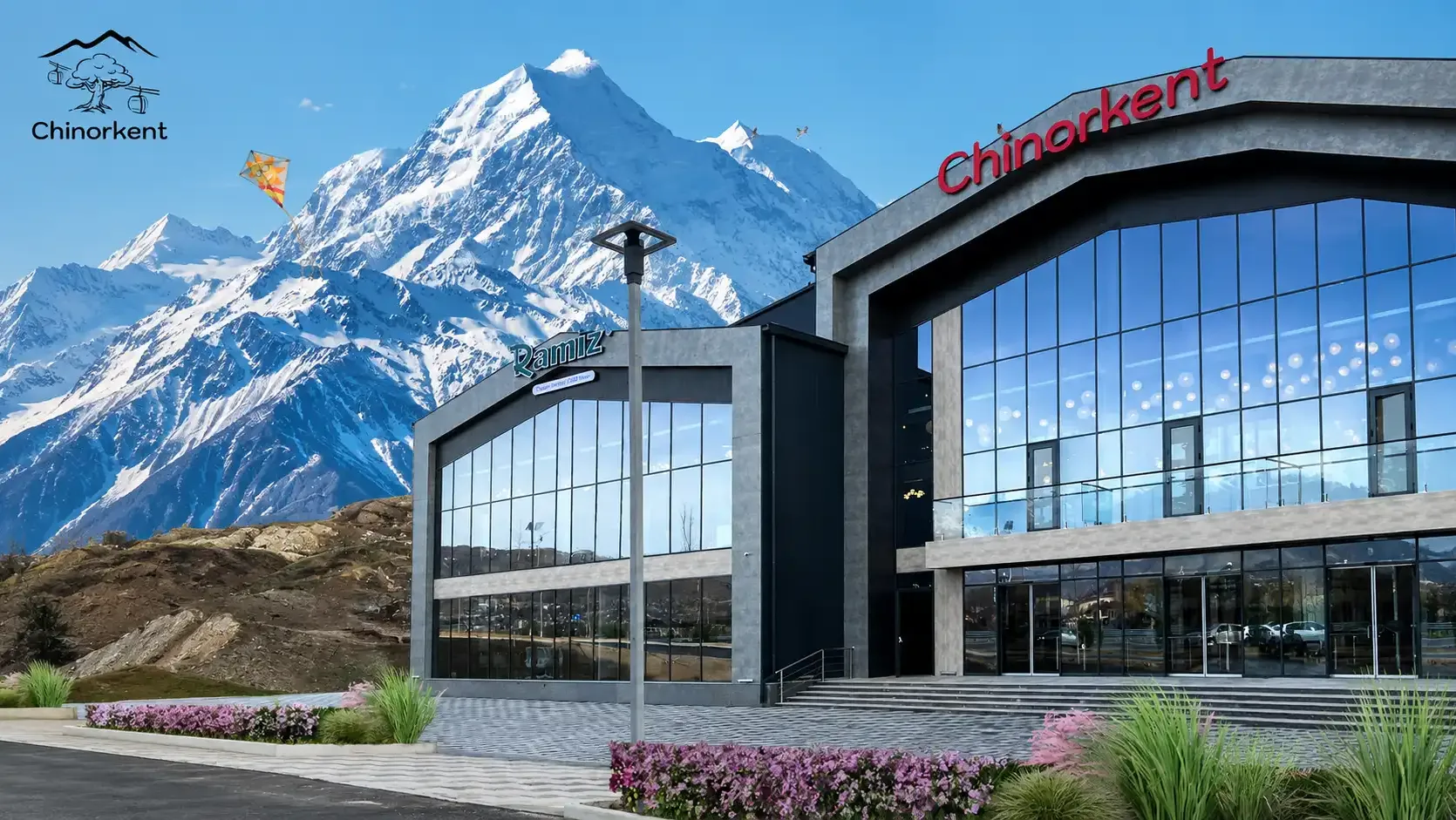 The glass-fronted Chinorkent cable-car terminal below snow-covered peaks.